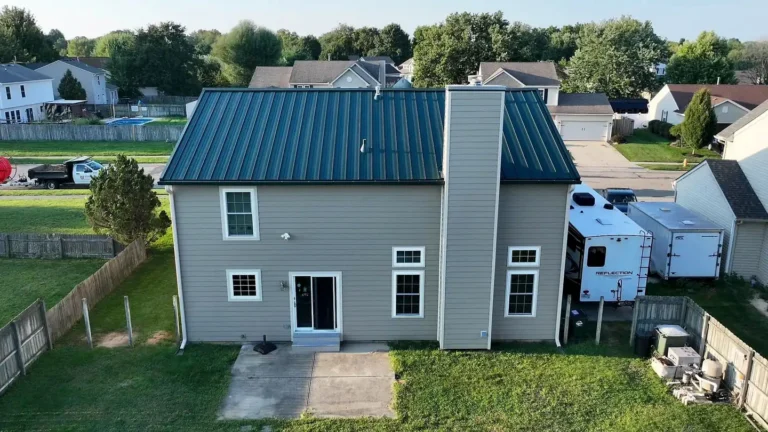 Rear of a Xenia, Ohio home with a new metal roof and new siding