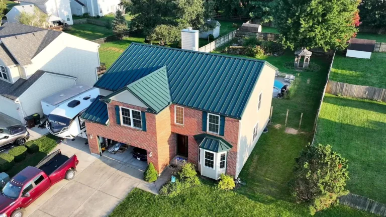 Green standing seam metal roof on a brick home in Xenia, Ohio
